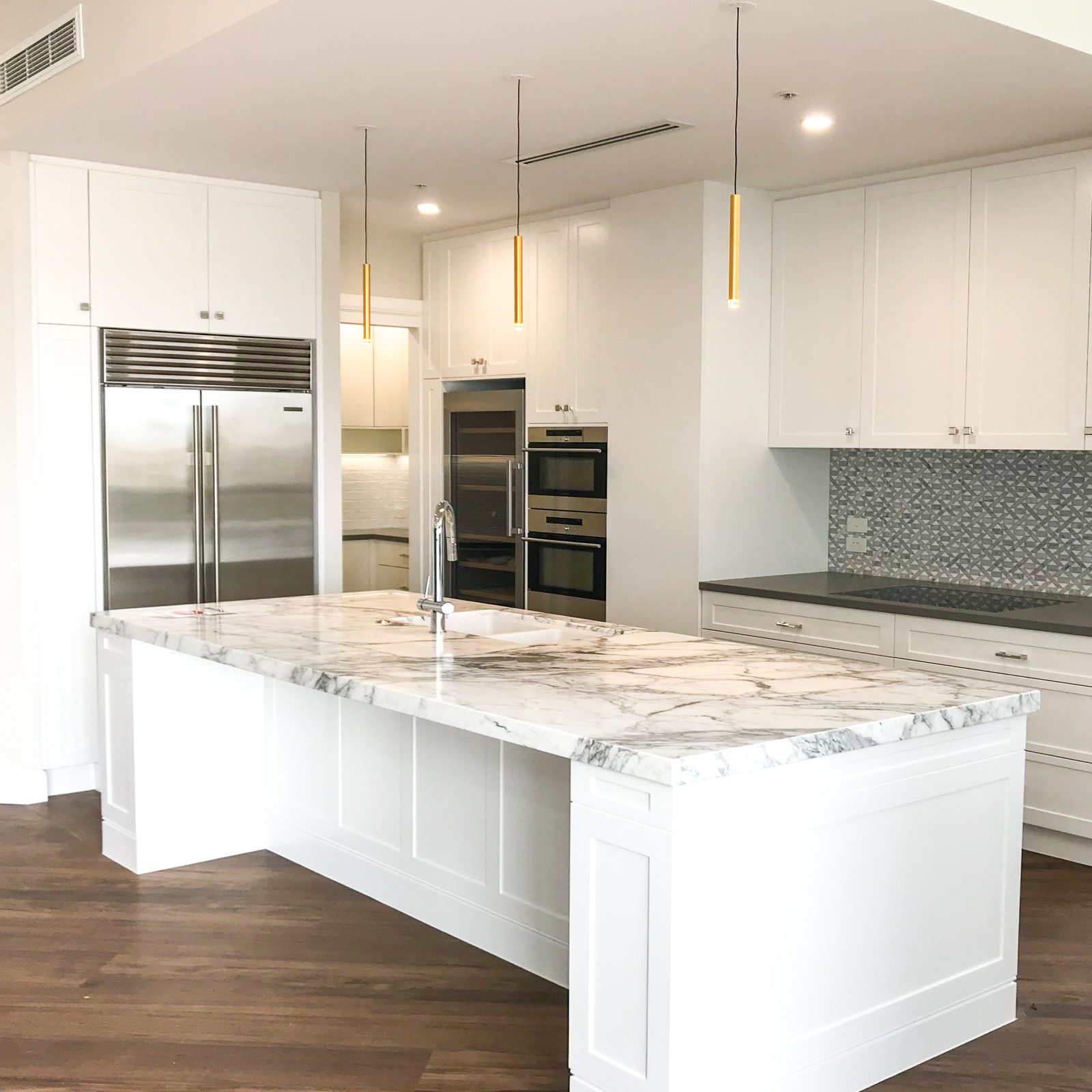 White shaker kitchen with marble island