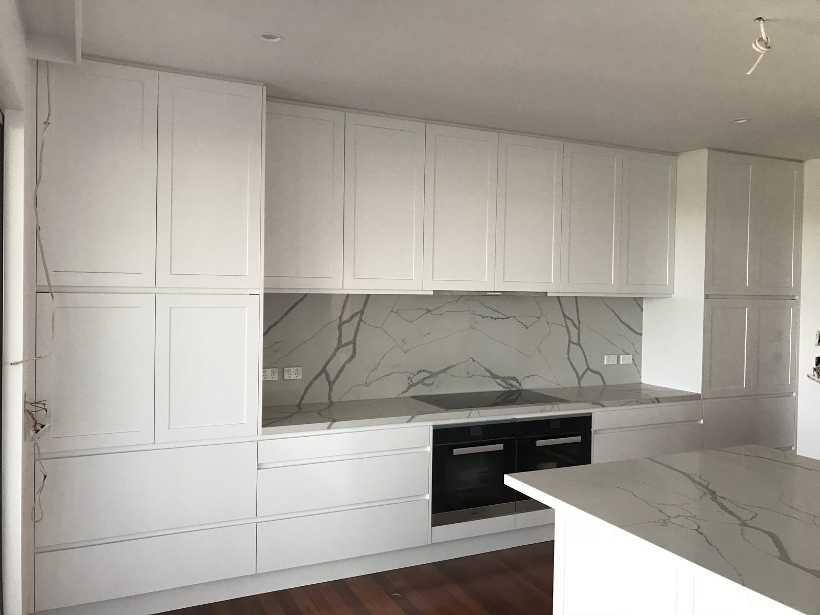 White kitchen with slab and shaker doors