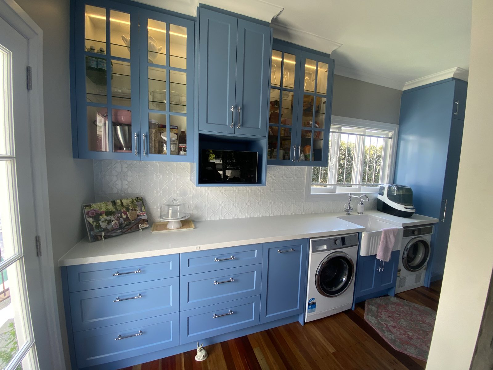 Blue shaker laundry with glass-front uppers