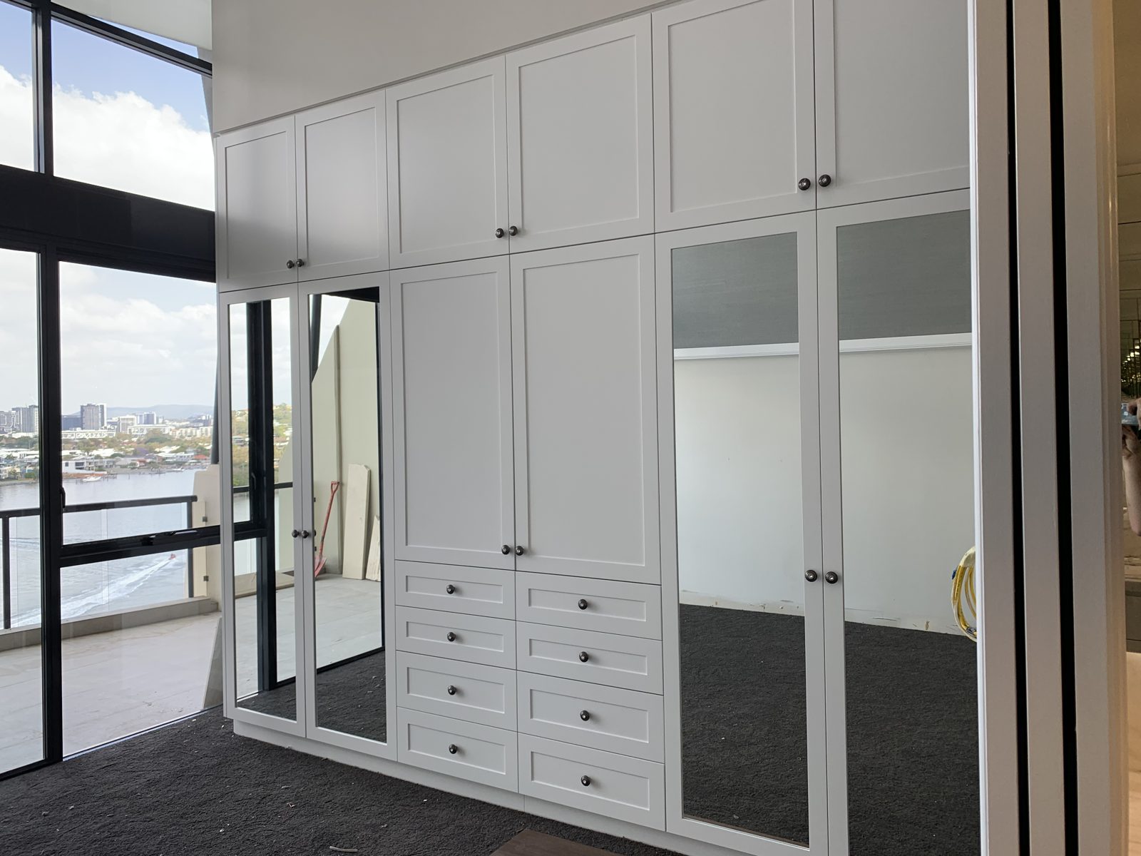 Built-in robe with shaker doors and mirrored panels