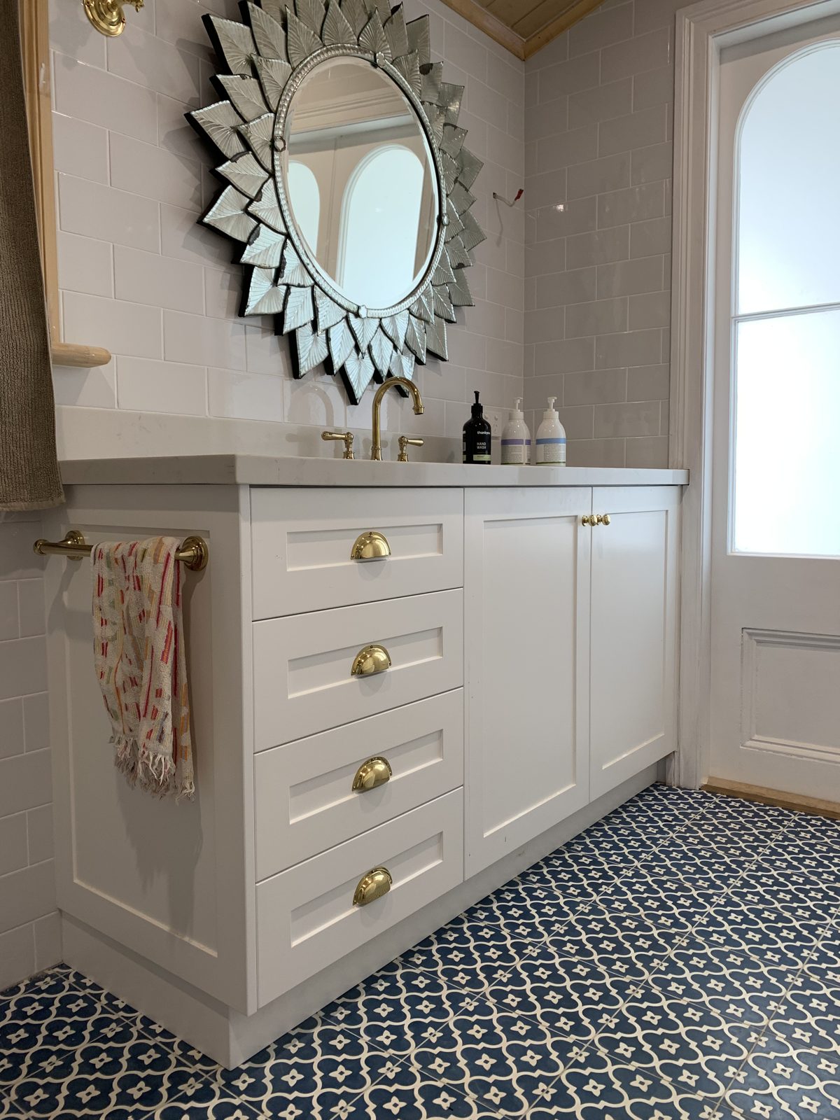 White shaker vanity with brass handles